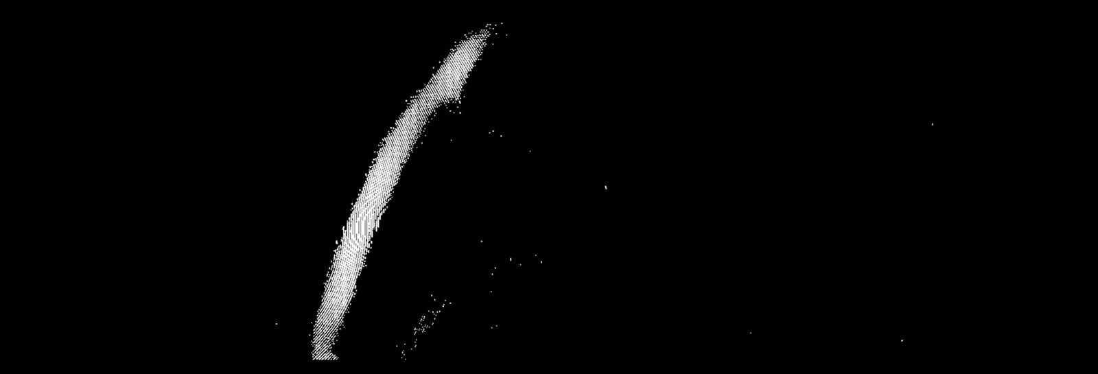 A pale fragment of a moving body against a black field